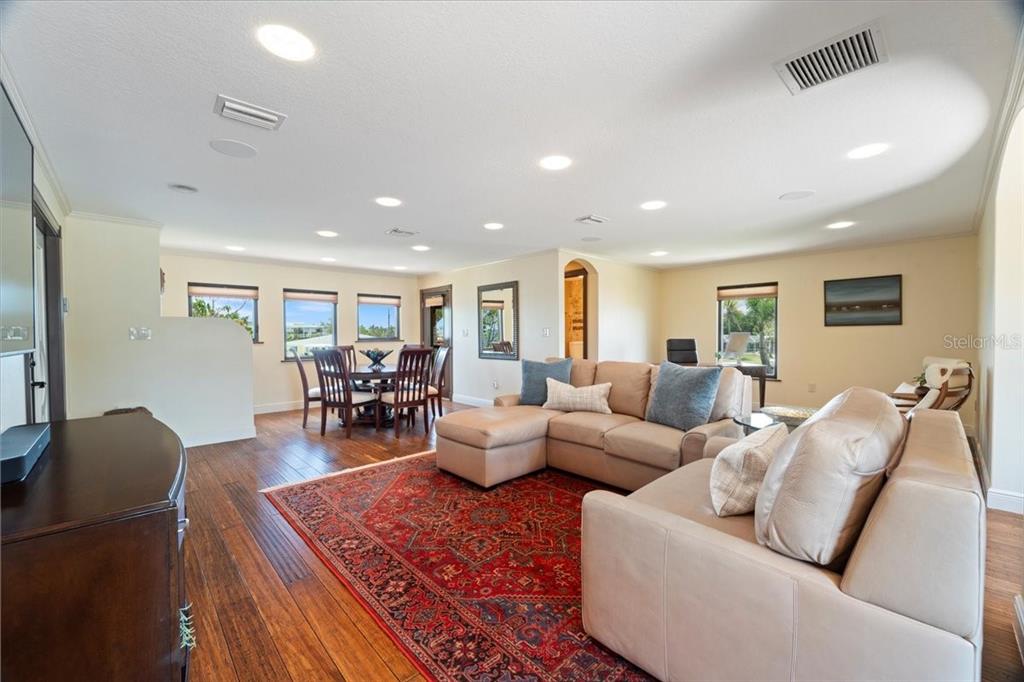 266 Bangsberg Road Southeast Port Charlotte, FL 33952 - Photo 75 of 100 a living room with furniture and wooden floor