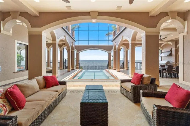 a view of living room with furniture and large windows