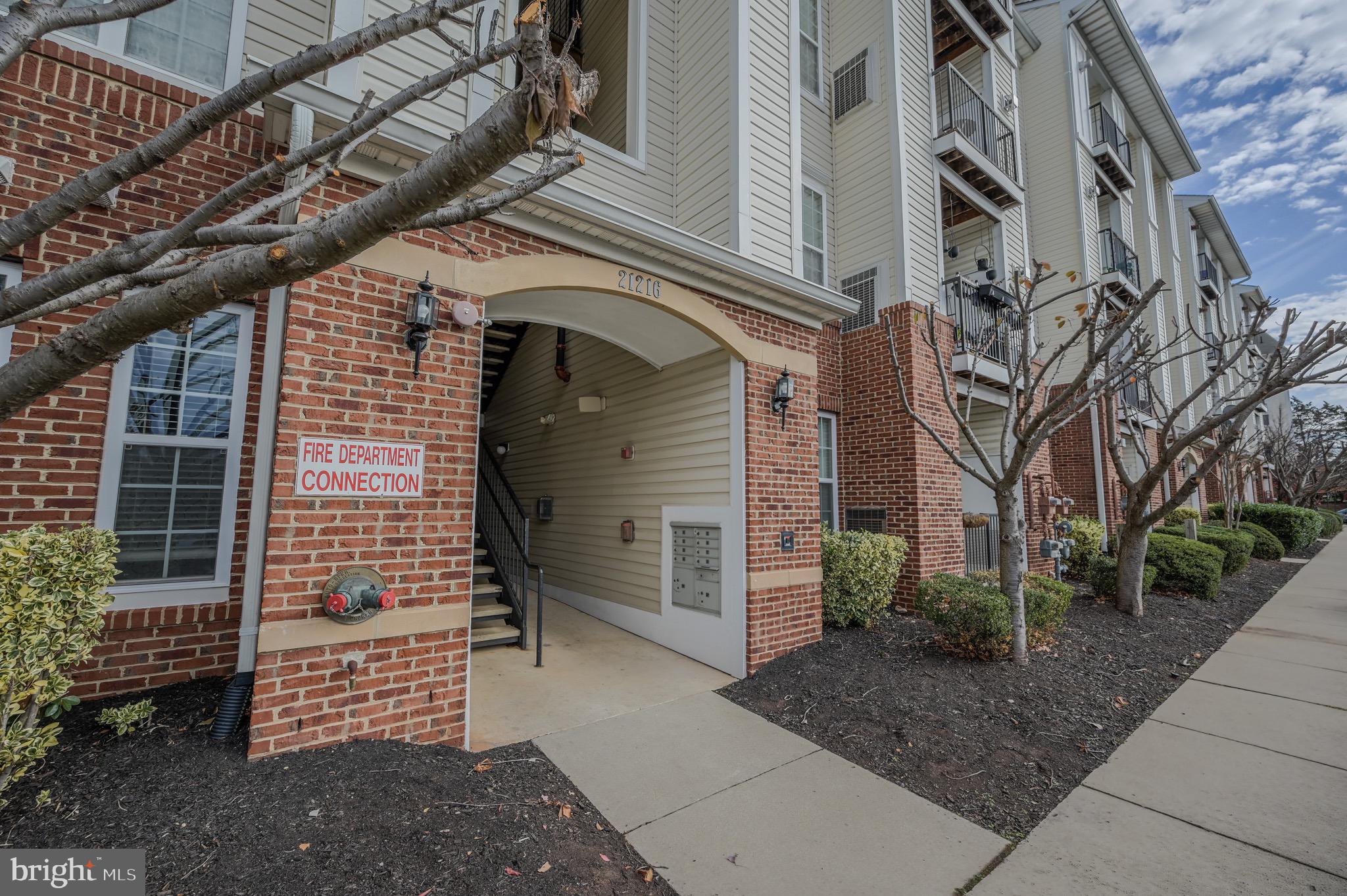 21216 McFadden Square, Unit 206 Sterling, VA 20165 - Photo 1 of 11 a front view of a building