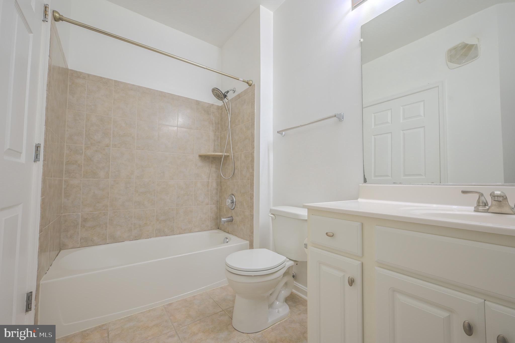 21216 McFadden Square, Unit 206 Sterling, VA 20165 - Photo 7 of 11 a bathroom with a toilet a sink and a bathtub