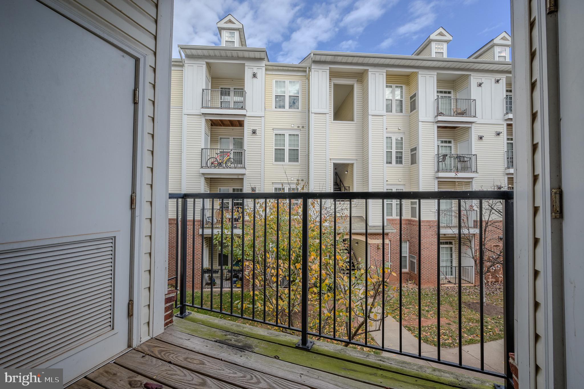 21216 McFadden Square, Unit 206 Sterling, VA 20165 - Photo 10 of 11 a view of a brick house with large windows