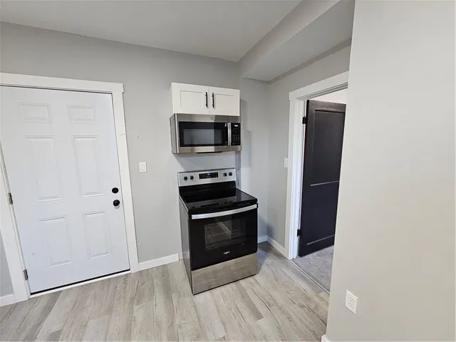 a kitchen with a stove and a microwave