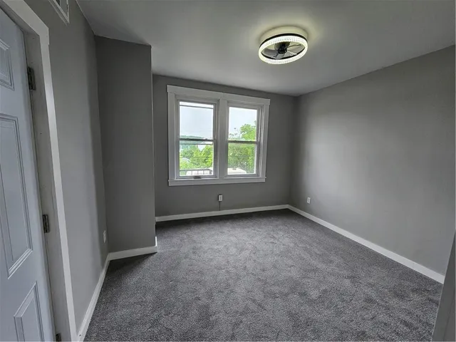 a view of a room with furniture and a window