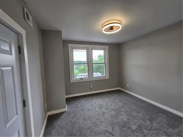 an empty room with windows and closet
