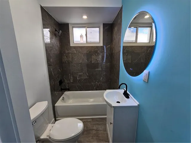 a bathroom with a sink toilet and a mirror