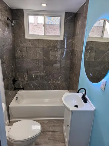 a bathroom with a toilet a sink and bathtub