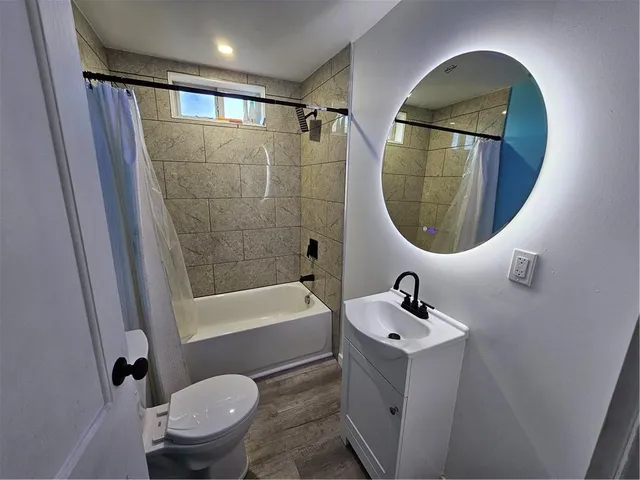 a bathroom with a sink toilet and a mirror