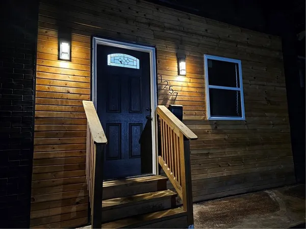 a view of front door of house with stairs