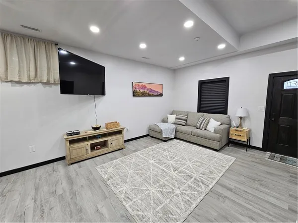 a living room with furniture and a flat screen tv