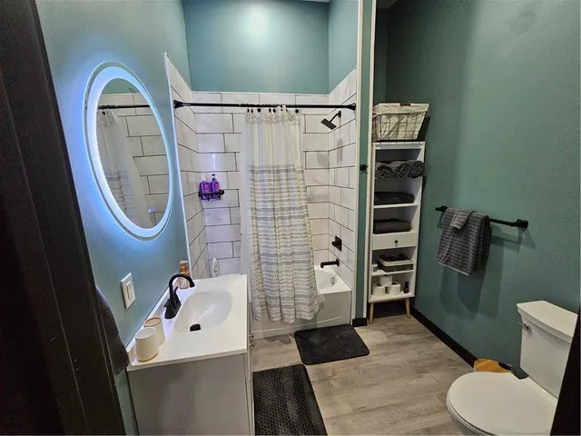 a bathroom with a sink toilet and shower