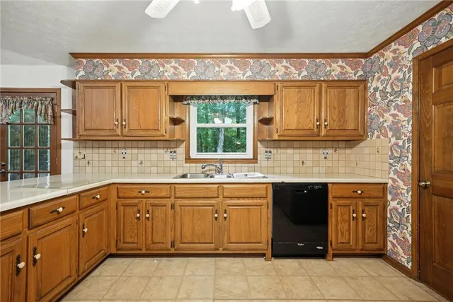 a kitchen with a sink window and cabinets