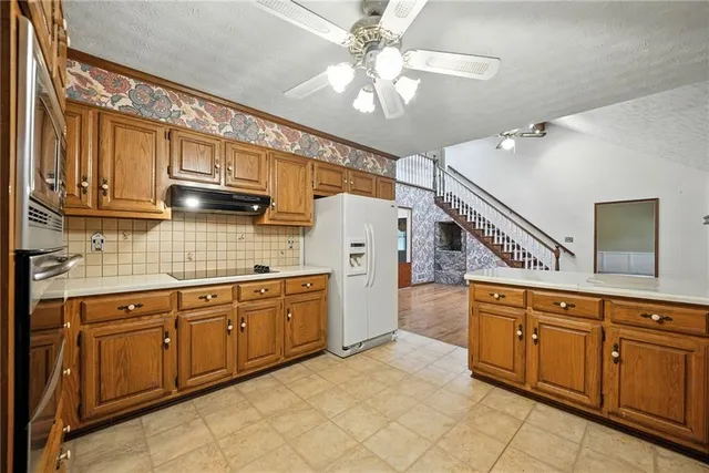 a kitchen with cabinets a sink and appliances