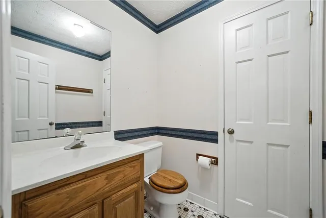 a bathroom with a sink a toilet and a mirror