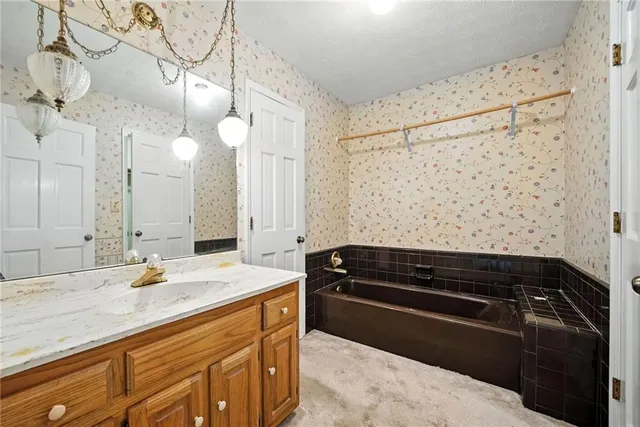a bathroom with a sink a granite counter tops and a shower