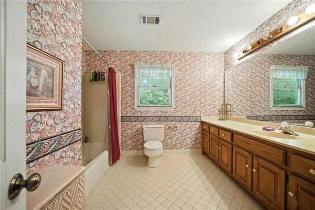 a spacious bathroom with a double vanity sink mirror and toilet