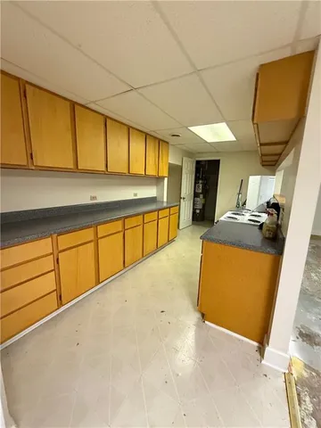 a view of a kitchen with stainless steel appliances wooden floor and a window