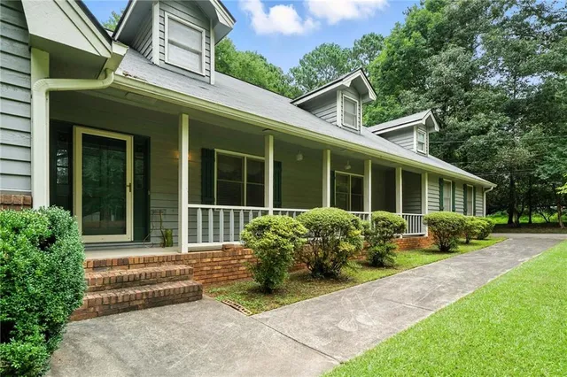 a front view of a house with garden