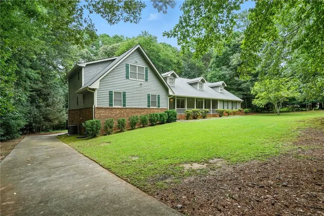 a front view of house with yard and green space