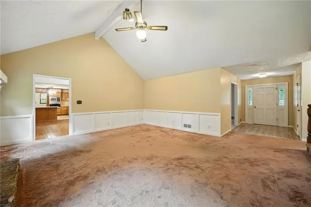 wooden floor in an empty room with a chandelier
