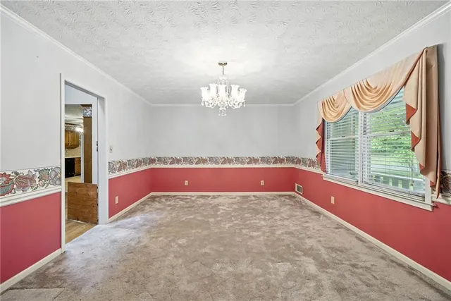 a view of kitchen with granite countertop cabinets and window