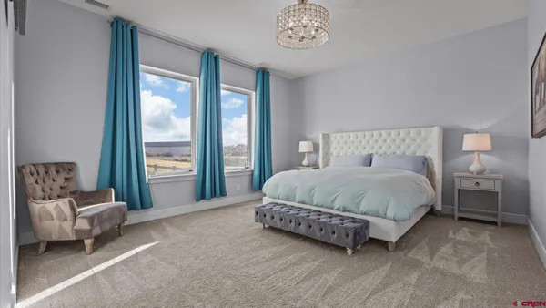 a spacious bedroom with a bed and a couch