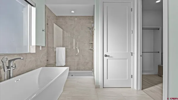 a bathroom with a tub shower and sink