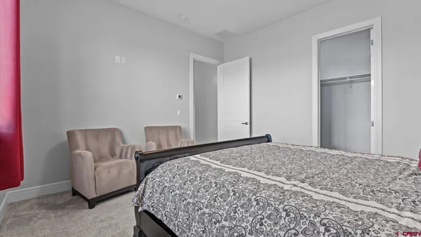 a bedroom with a bed and chair