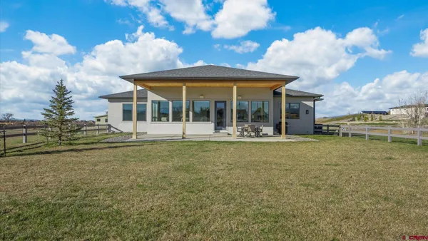 a view of a house with a backyard porch and sitting area