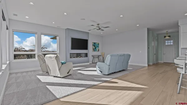 a living room with furniture a flat screen tv and a fireplace