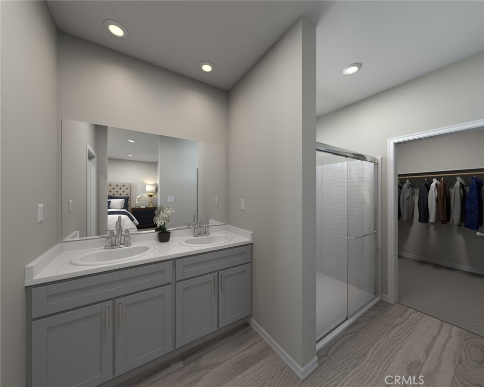 28563 Via Navarra Temecula, CA 92591 - Photo 6 of 9 a en suite bathroom with a double vanity sink and mirror