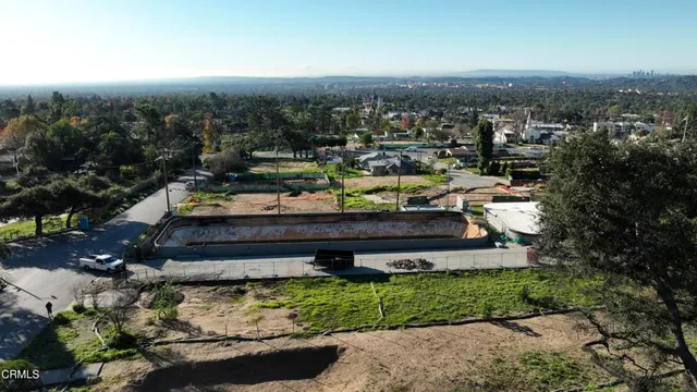 an aerial view of a house with a yard basket ball court and outdoor seating