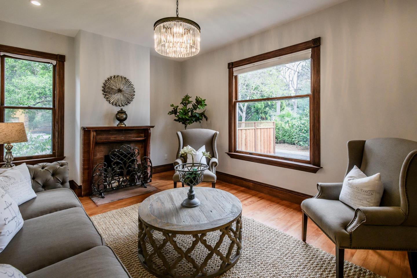1136 Waverley Street Palo Alto, CA 94301 - Photo 12 of 28 a living room with furniture a fireplace and a large window