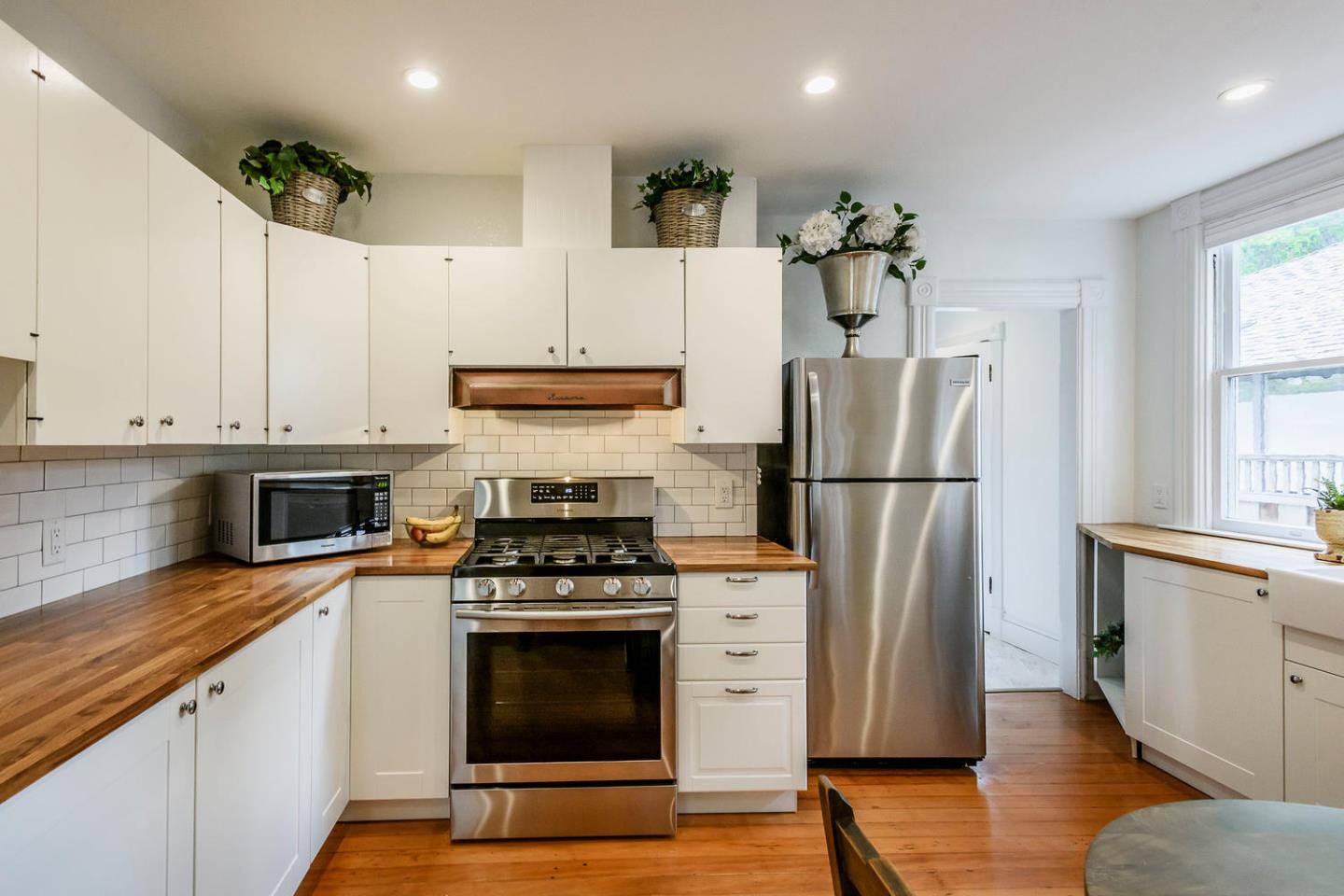 1136 Waverley Street Palo Alto, CA 94301 - Photo 14 of 28 a kitchen with a refrigerator stove and white cabinets