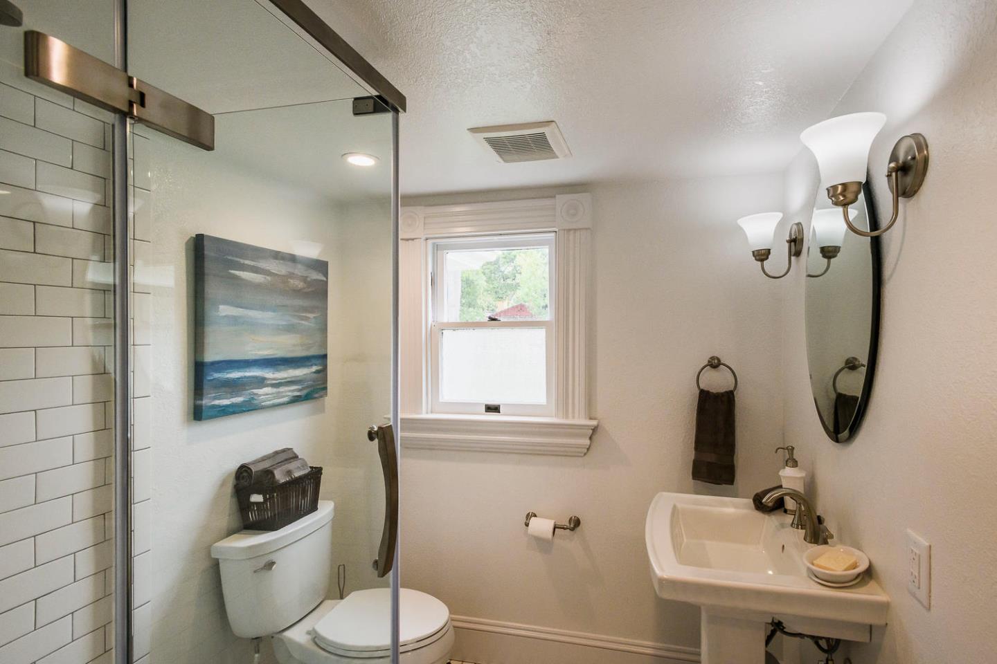 1136 Waverley Street Palo Alto, CA 94301 - Photo 15 of 28 a bathroom with a toilet sink and mirror