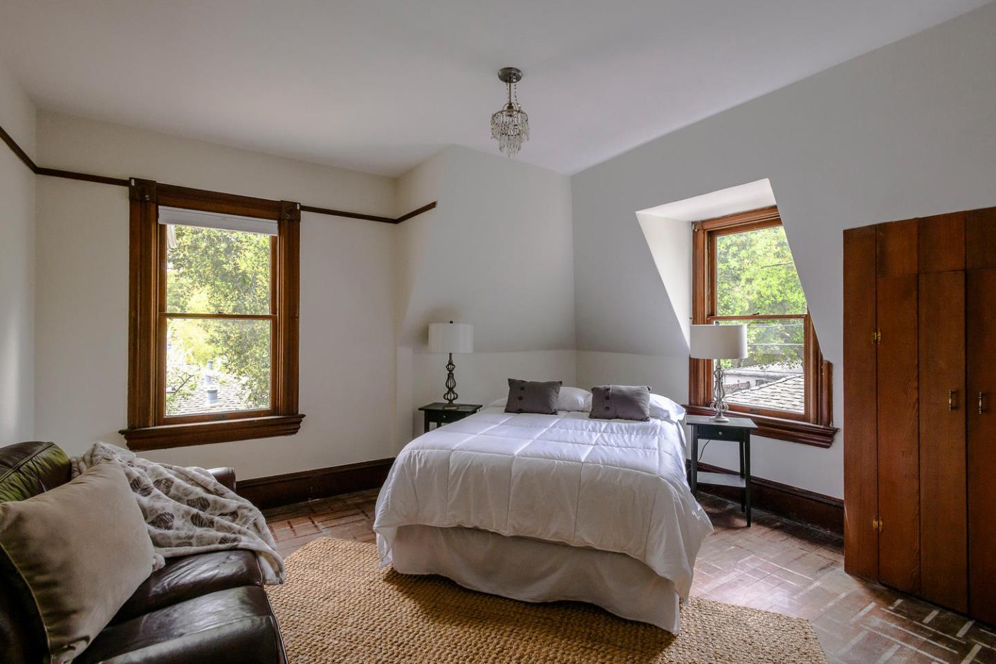 1136 Waverley Street Palo Alto, CA 94301 - Photo 21 of 28 a bedroom with a bed window and mirror