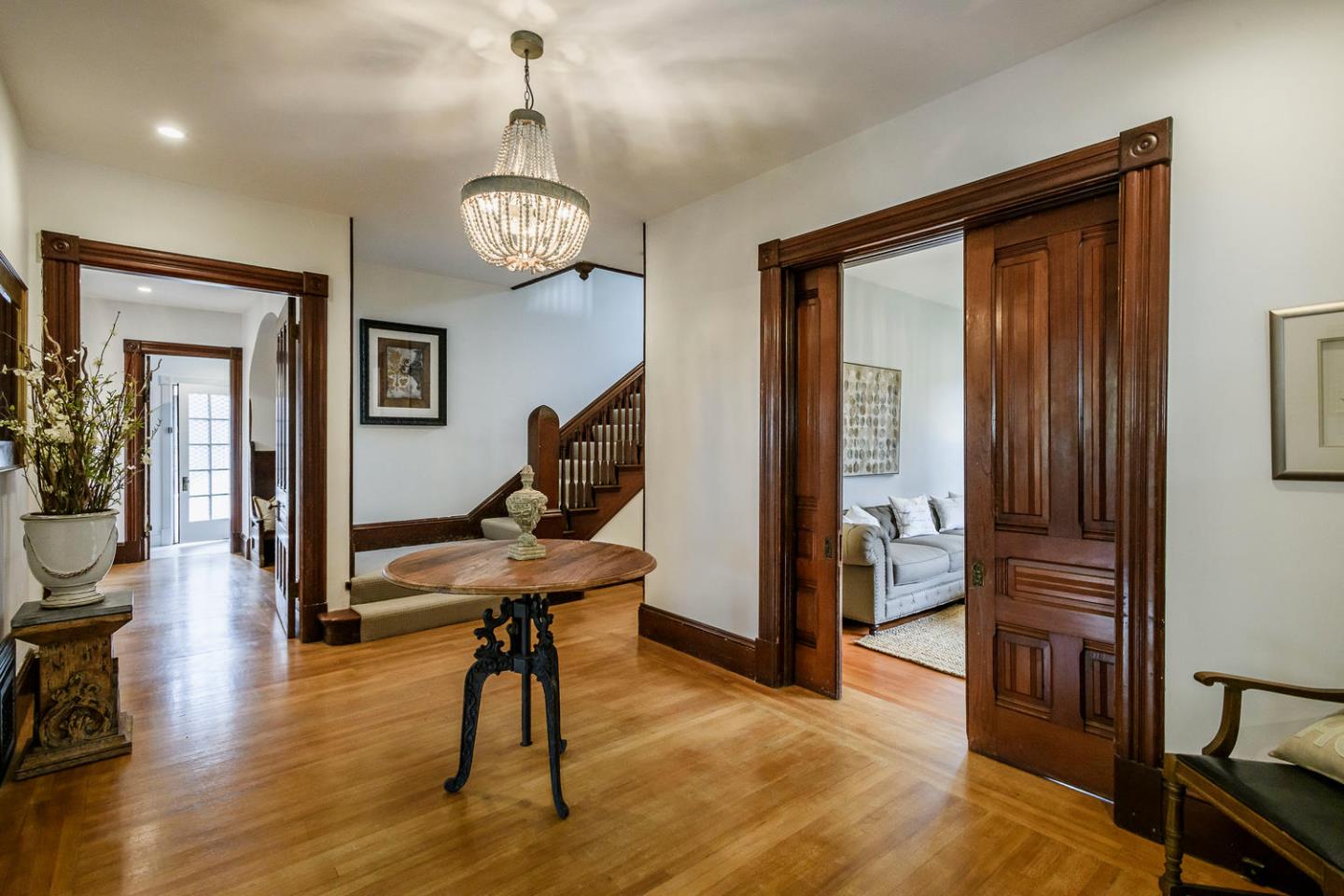 1136 Waverley Street Palo Alto, CA 94301 - Photo 4 of 28 a view of a livingroom with furniture wooden floor and a chandelier