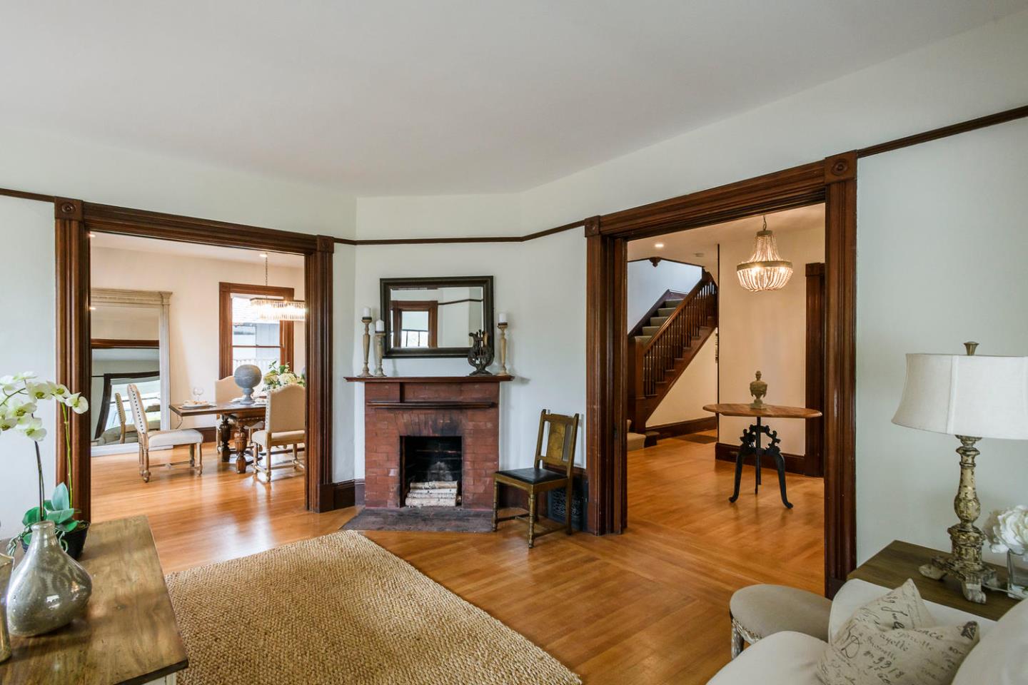 1136 Waverley Street Palo Alto, CA 94301 - Photo 5 of 28 a living room with furniture a fireplace and a table