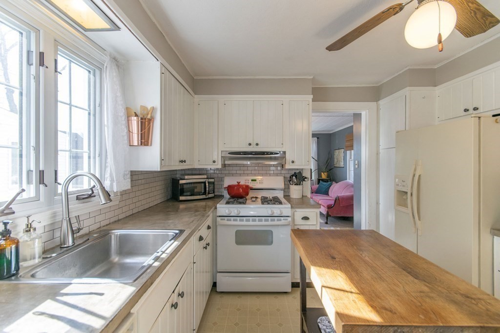 114 Appleton Street Springfield, MA 01108 - Photo 14 of 35 a kitchen with a stove a refrigerator and a sink