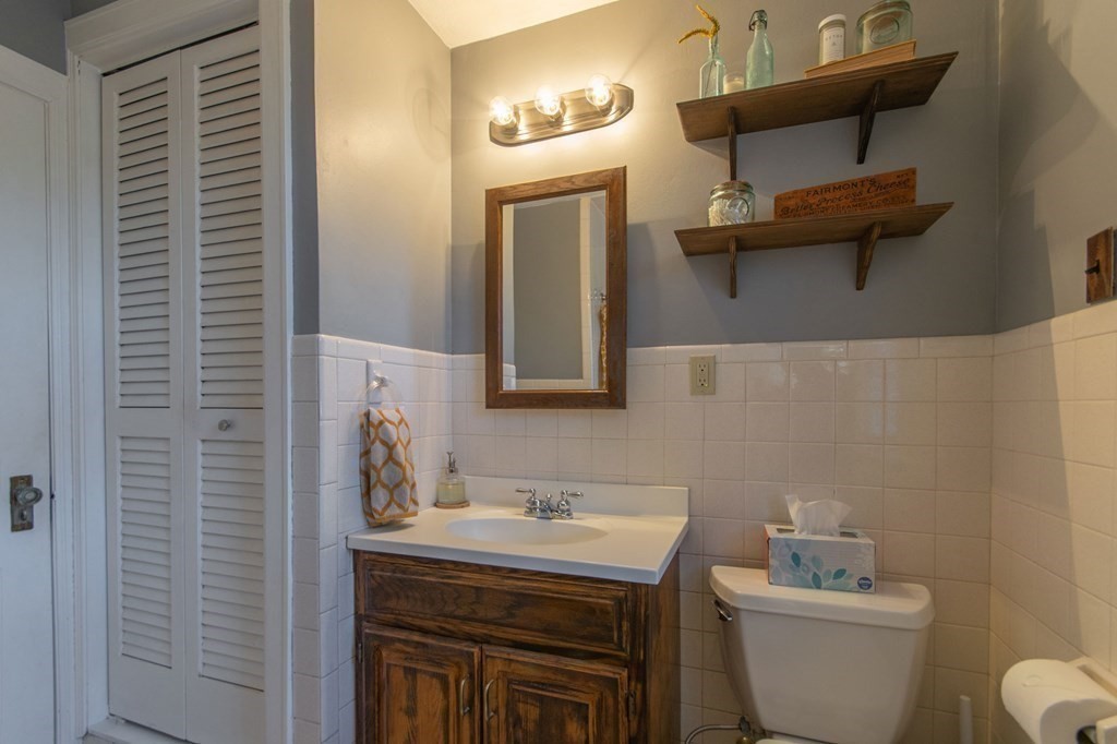 114 Appleton Street Springfield, MA 01108 - Photo 26 of 35 a bathroom with a toilet a sink and mirror