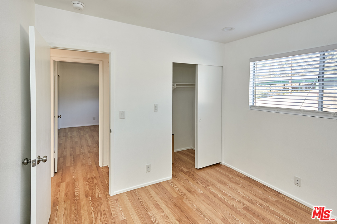 433 Cottage Home Street, Unit 4 Los Angeles, CA 90012 - Photo 11 of 13 a view of a room with wooden floor and a window