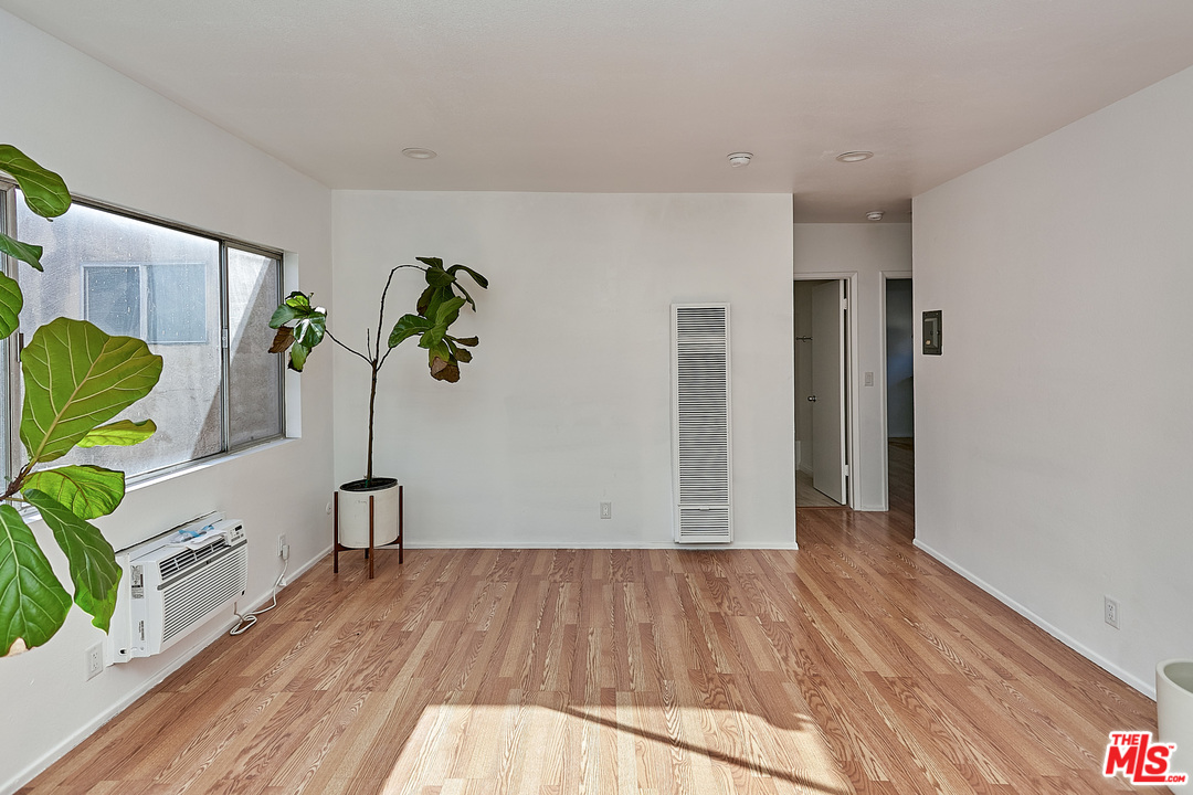 433 Cottage Home Street, Unit 4 Los Angeles, CA 90012 - Photo 3 of 13 a view of empty room with wooden floor
