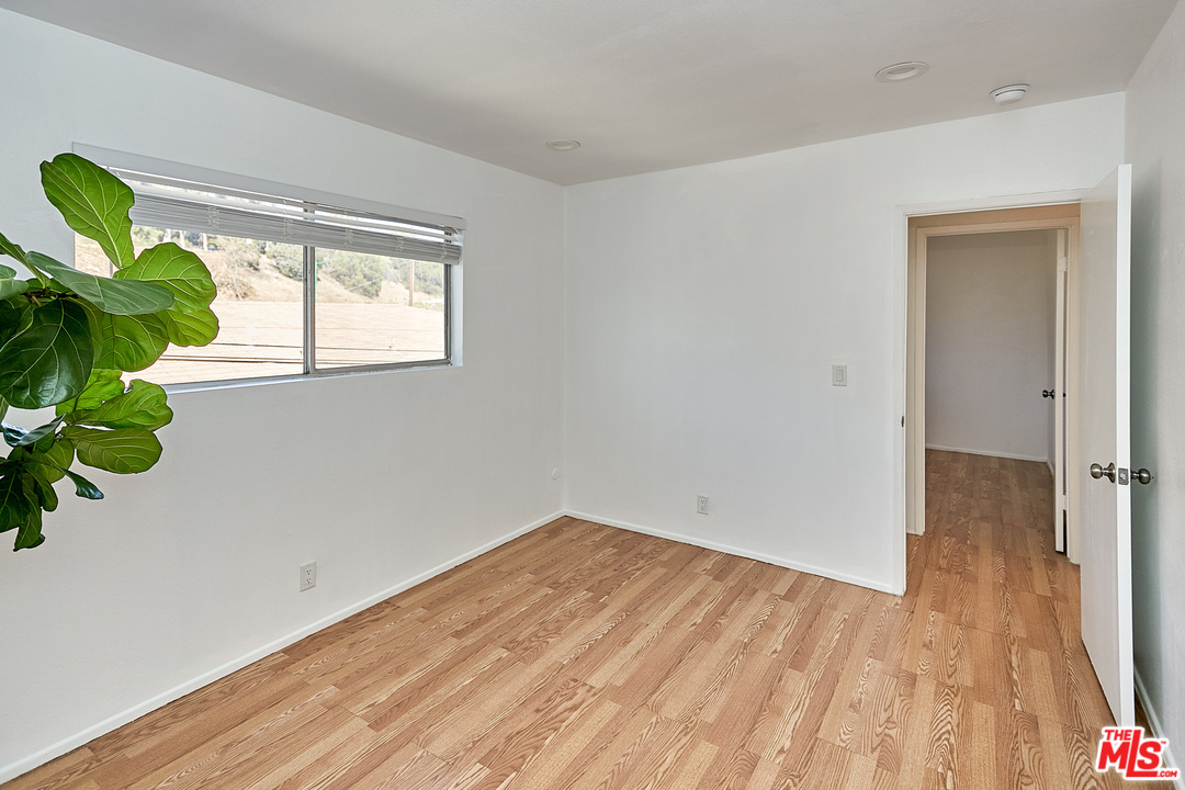 433 Cottage Home Street, Unit 4 Los Angeles, CA 90012 - Photo 7 of 13 a view of empty room with wooden floor and fan