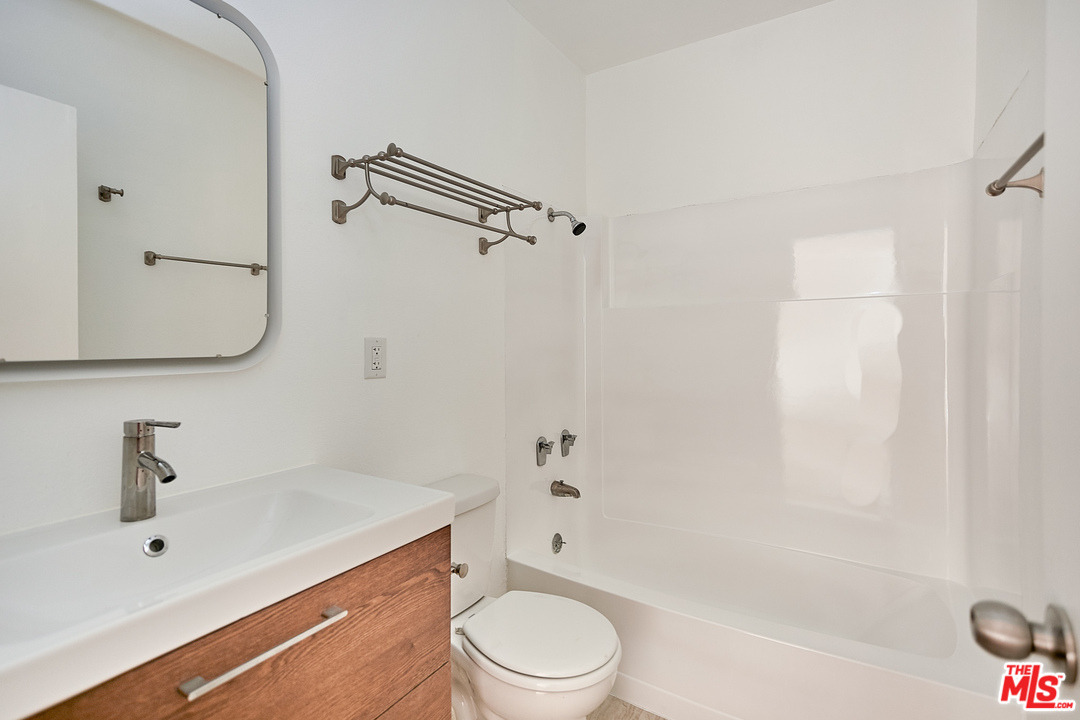 433 Cottage Home Street, Unit 4 Los Angeles, CA 90012 - Photo 8 of 13 a bathroom with a sink a toilet and shower