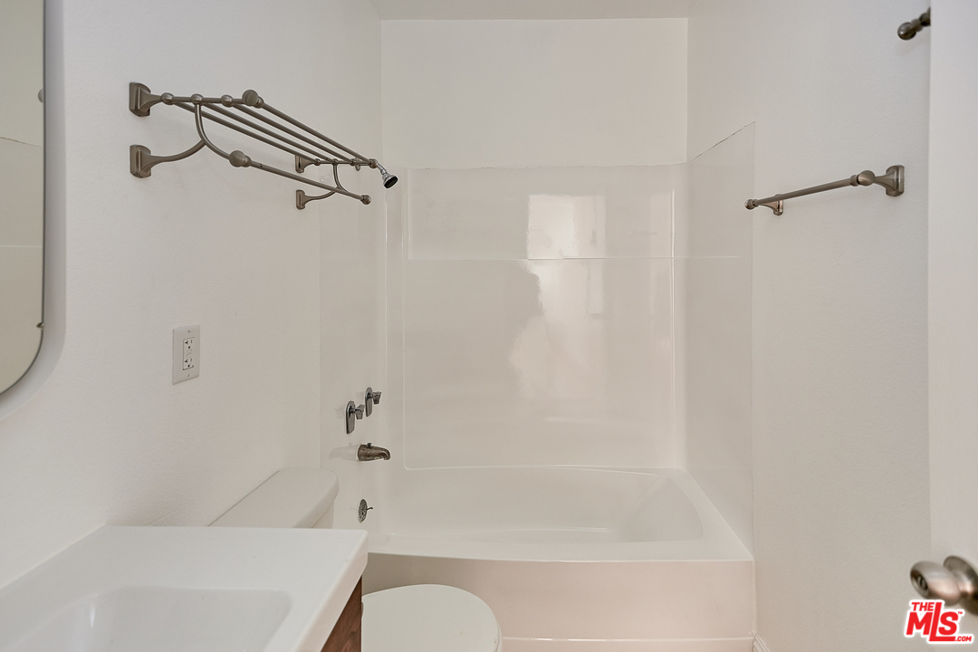 433 Cottage Home Street, Unit 4 Los Angeles, CA 90012 - Photo 9 of 13 a bathroom with a bathtub and a shower