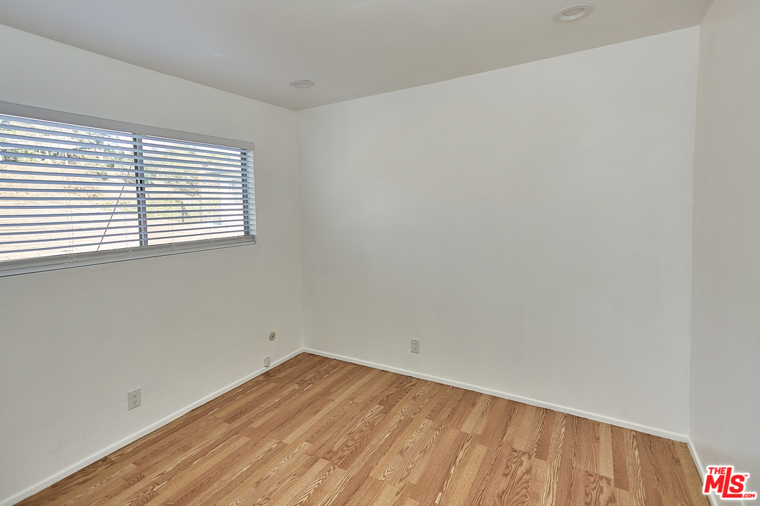 433 Cottage Home Street, Unit 4 Los Angeles, CA 90012 - Photo 10 of 13 an empty room with a window