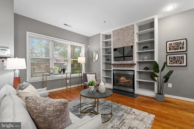 a living room with furniture a fireplace and a flat screen tv