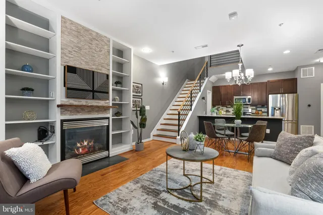 a living room with furniture and a fireplace