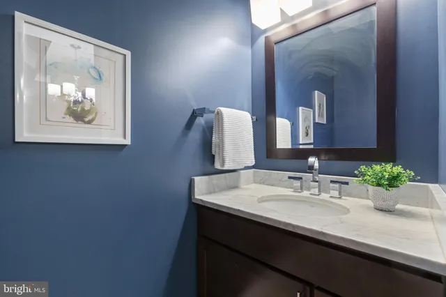 a bathroom with a sink and two mirror