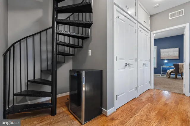 a view of hallway with stairs and wooden floor