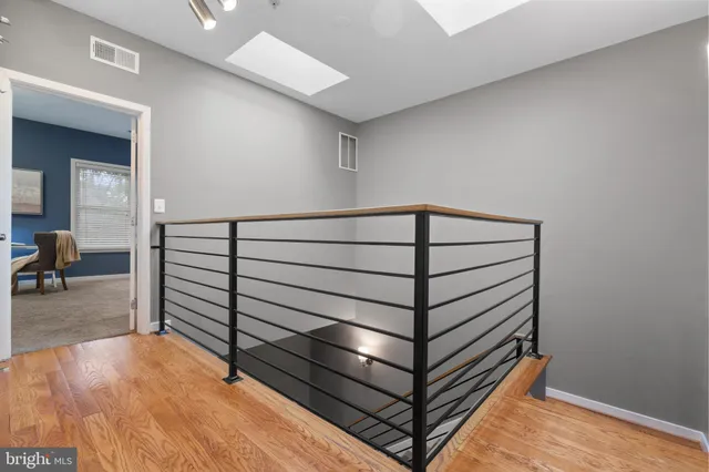 a view of an empty room and wooden floor